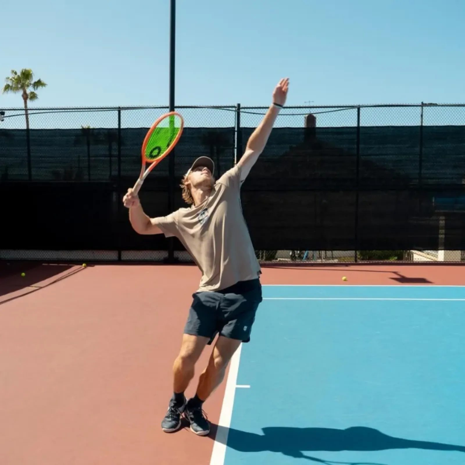 Saturday UTR match play — player serving on a blue court at LBTA
