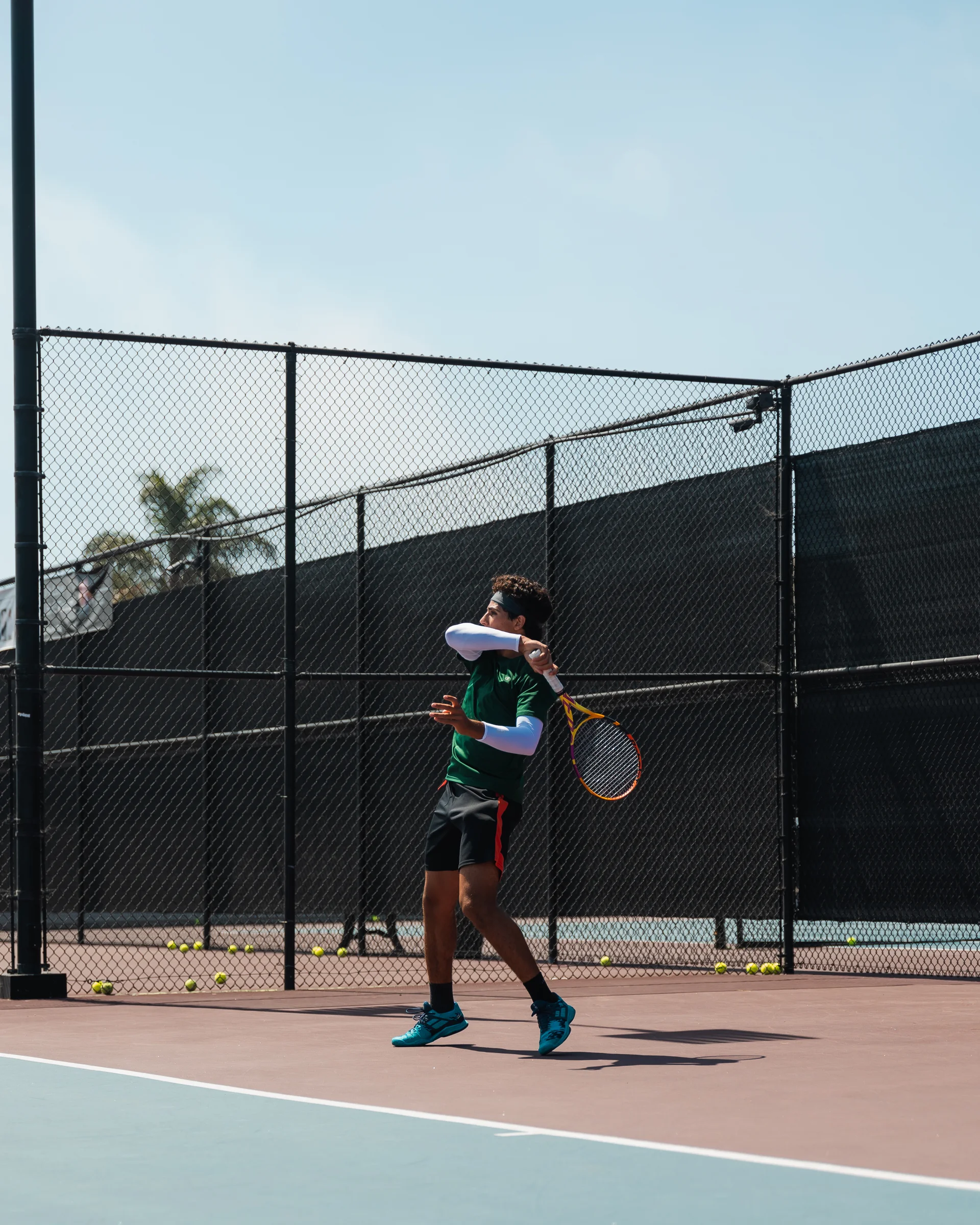 A player following through on a two-handed backhand