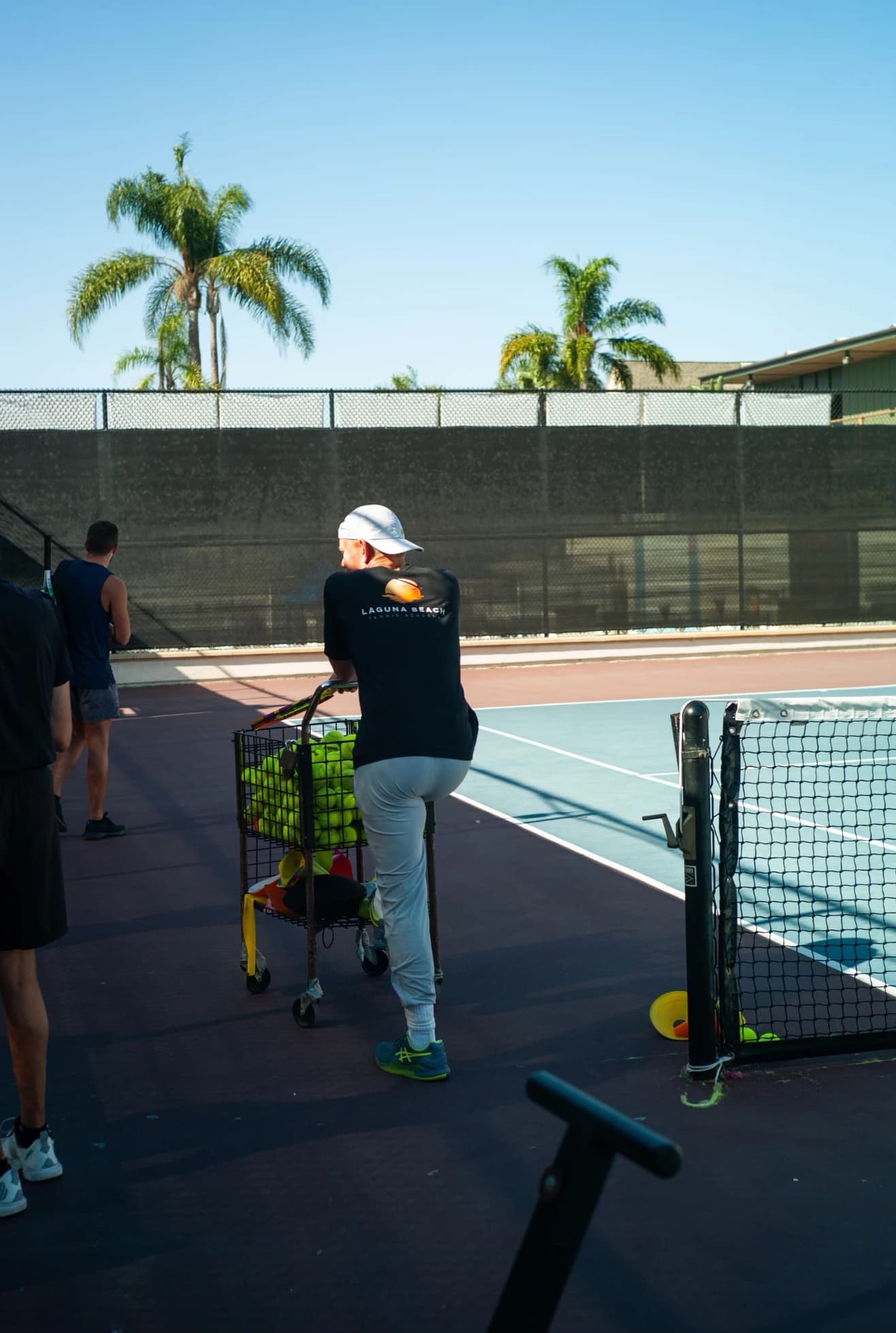 Coach with ball cart during a session at LBTA