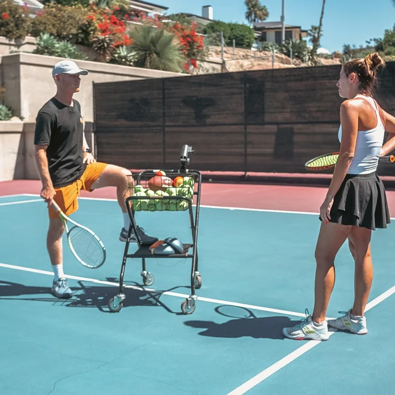 Private lesson — coach and athlete with ball cart at LBTA