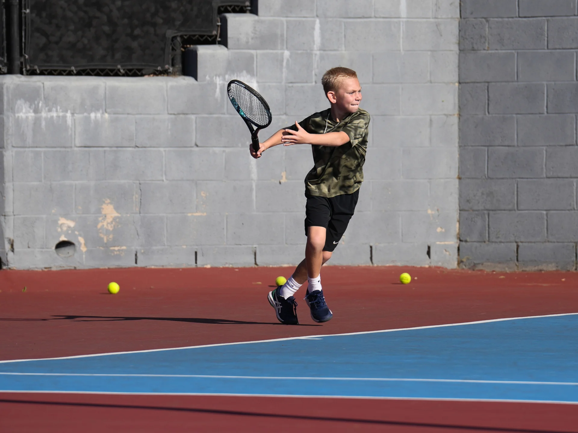 A young player learning the game on an LBTA court