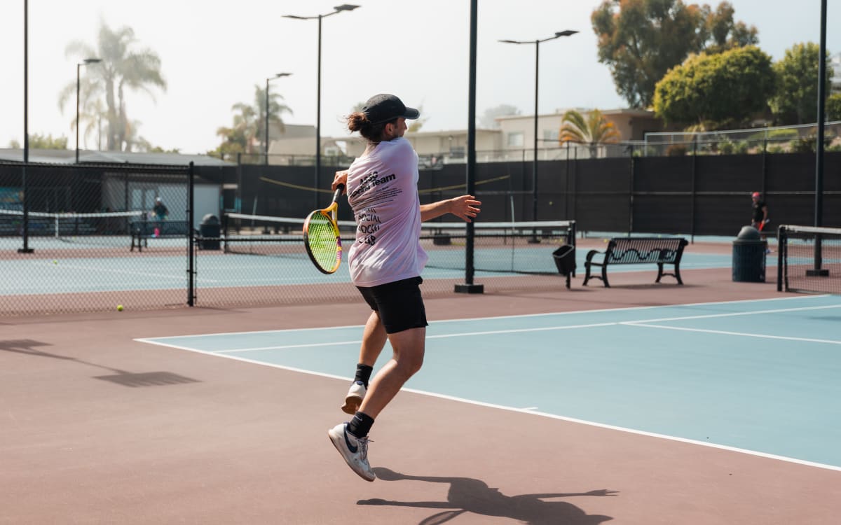 A player airborne through a forehand during a continuous drill