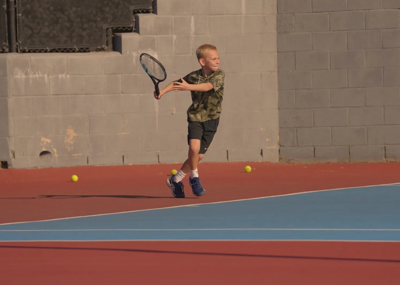 A player driving a two-handed backhand on court