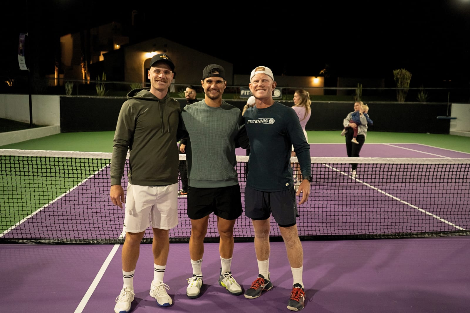 Andrew Mateljan at the net with two touring professionals under lights